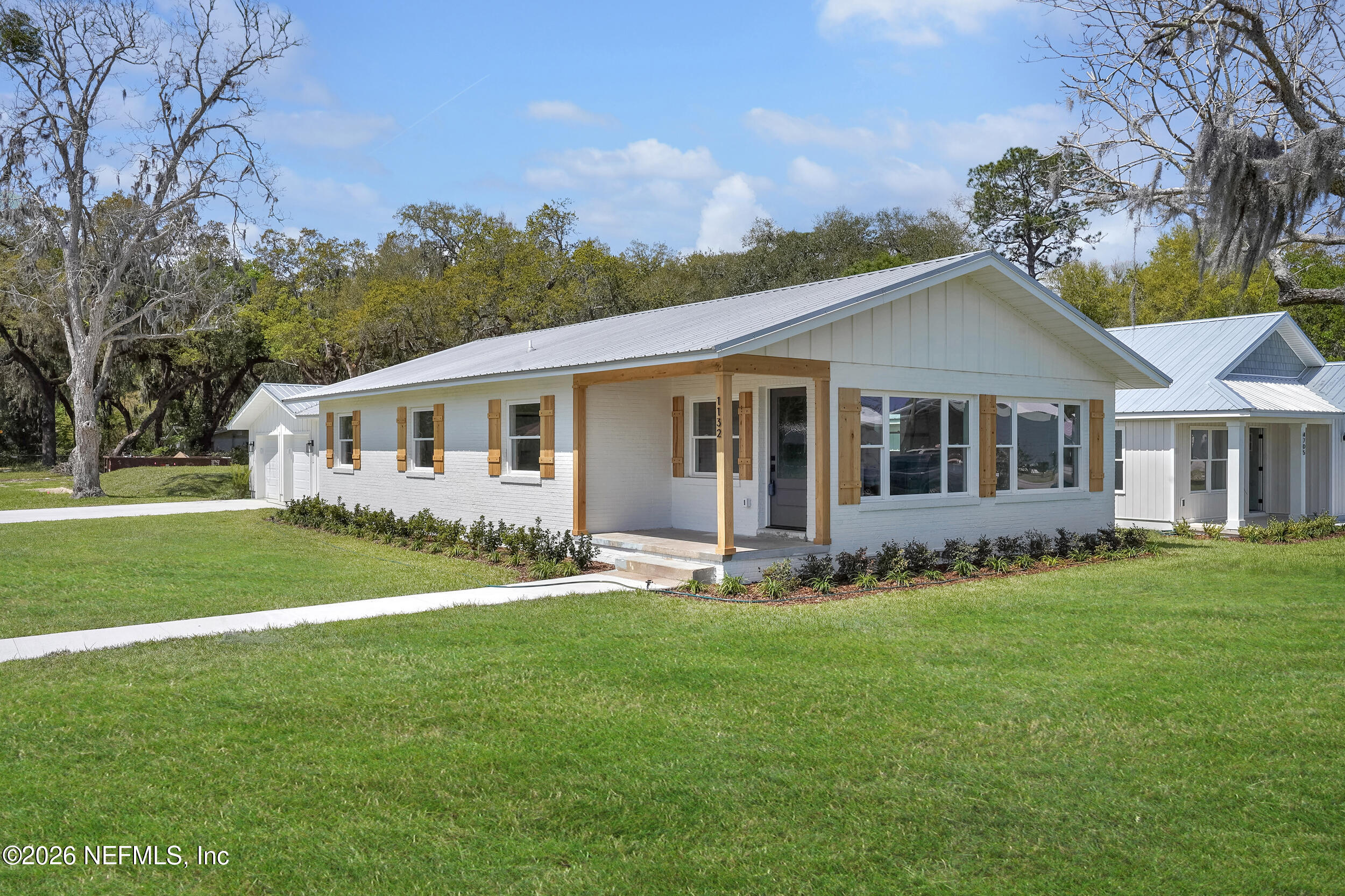 1132 5th Street St. Augustine, FL 32095 - Photo 2 of 34 a front view of a house with a garden