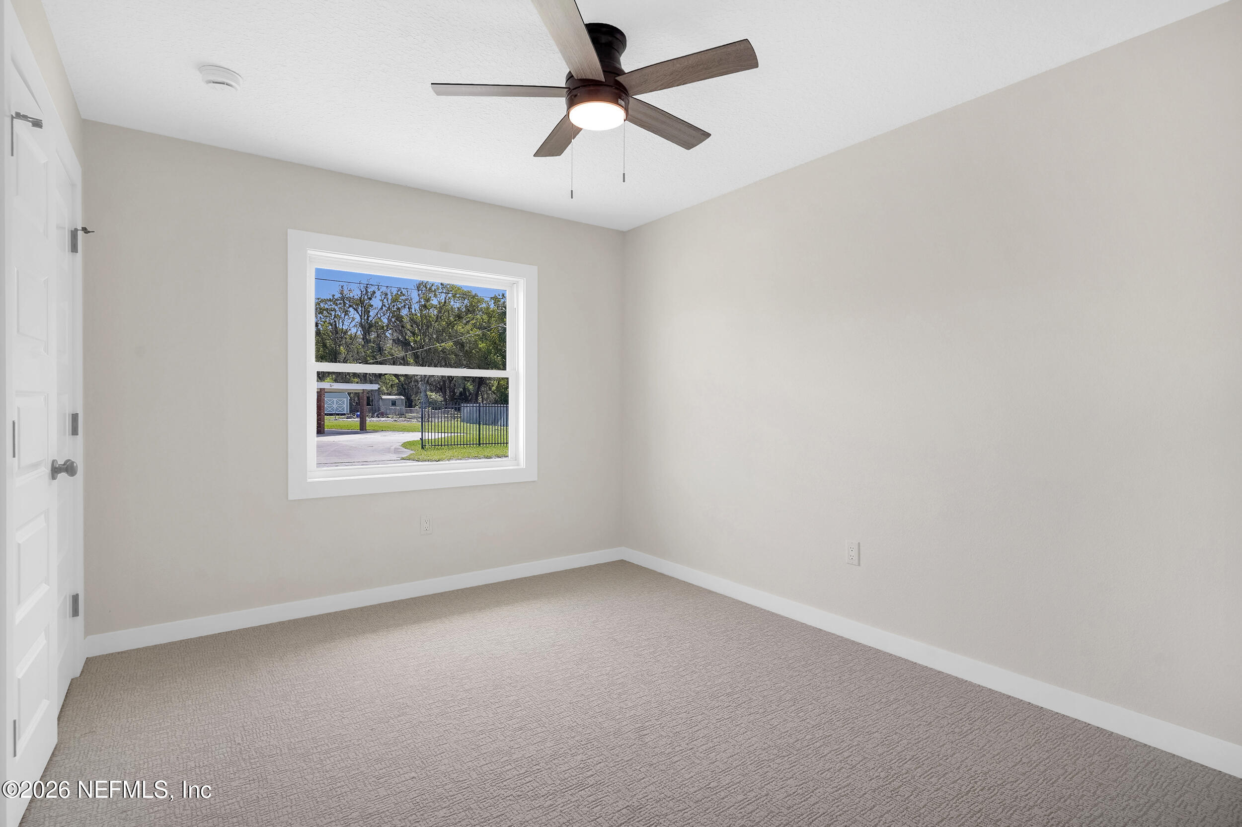 1132 5th Street St. Augustine, FL 32095 - Photo 24 of 34 an empty room with a window and a fan