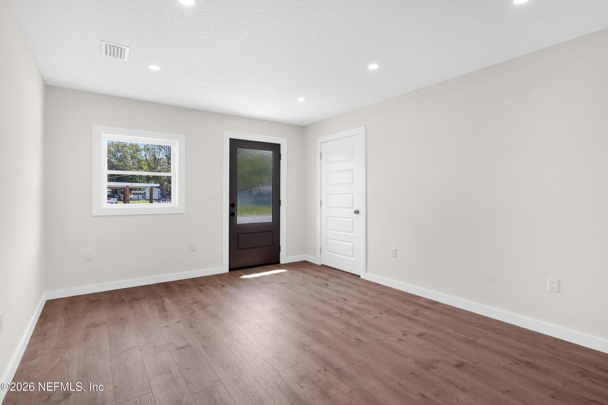 1132 5th Street St. Augustine, FL 32095 - Photo 27 of 34 a view of an empty room with wooden floor and a window