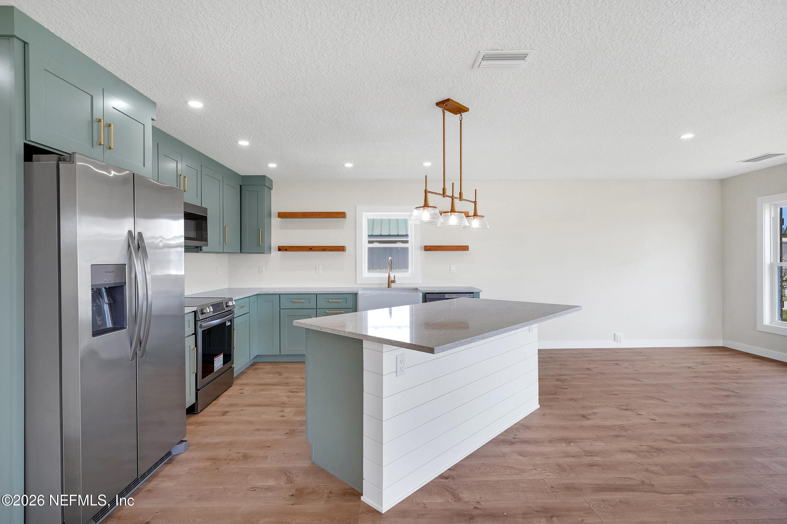 1132 5th Street St. Augustine, FL 32095 - Photo 10 of 34 a kitchen with stainless steel appliances granite countertop a sink and a refrigerator