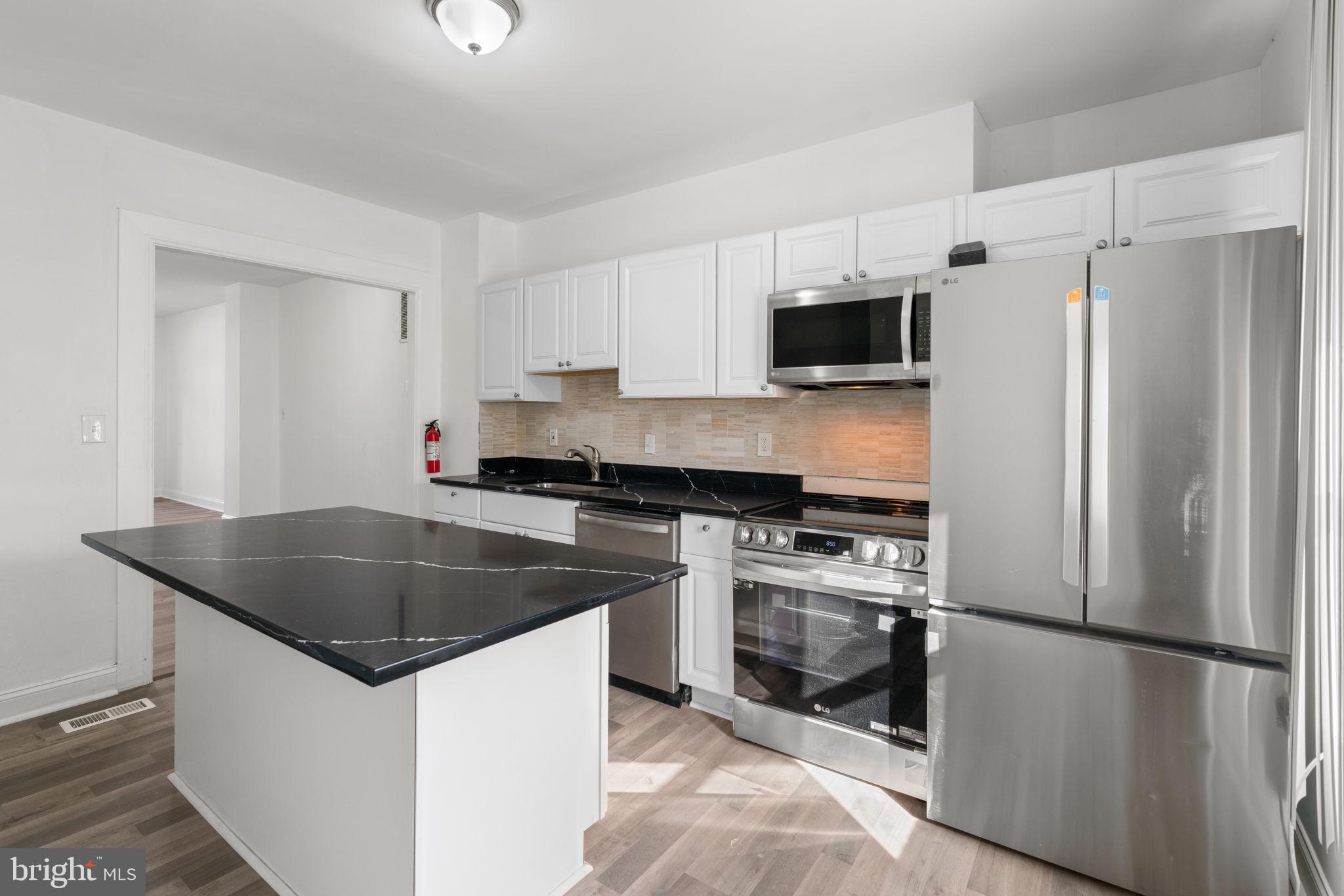 1731 Cliftview Avenue Baltimore, MD 21213 - Photo 12 of 33 a kitchen with a refrigerator stove and microwave