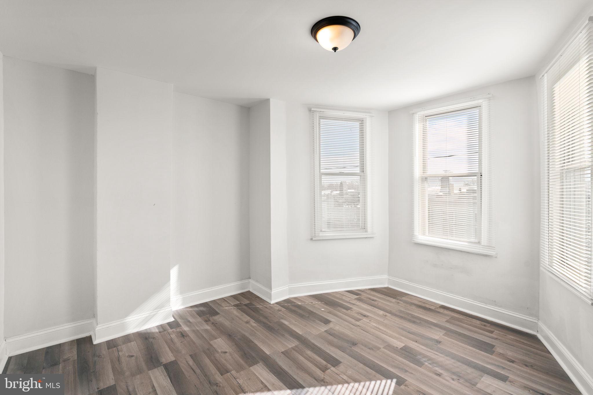 1731 Cliftview Avenue Baltimore, MD 21213 - Photo 13 of 33 an empty room with wooden floor and windows