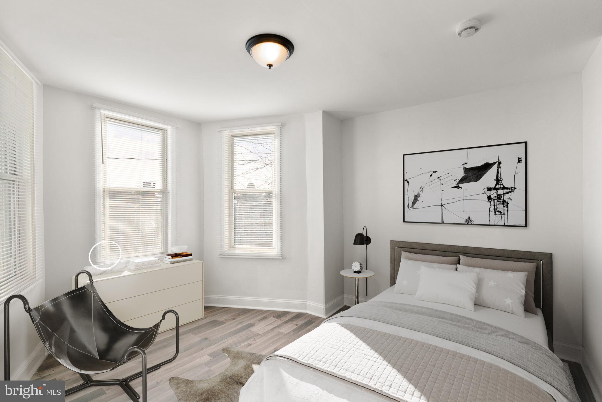 1731 Cliftview Avenue Baltimore, MD 21213 - Photo 14 of 33 a bedroom with a bed and a chair