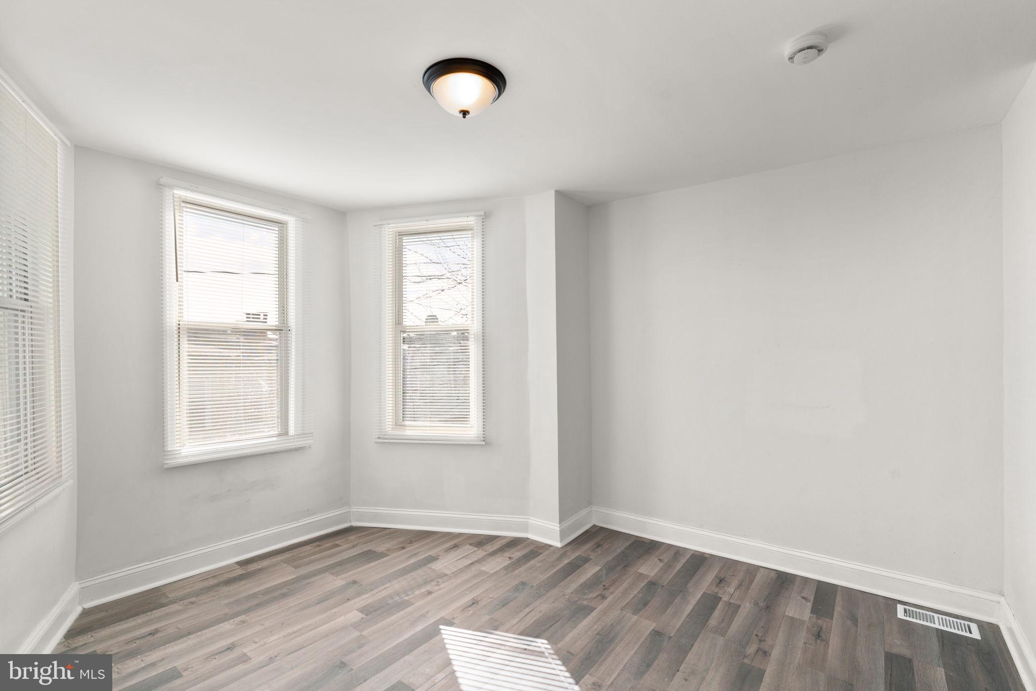 1731 Cliftview Avenue Baltimore, MD 21213 - Photo 15 of 33 an empty room with wooden floor and windows