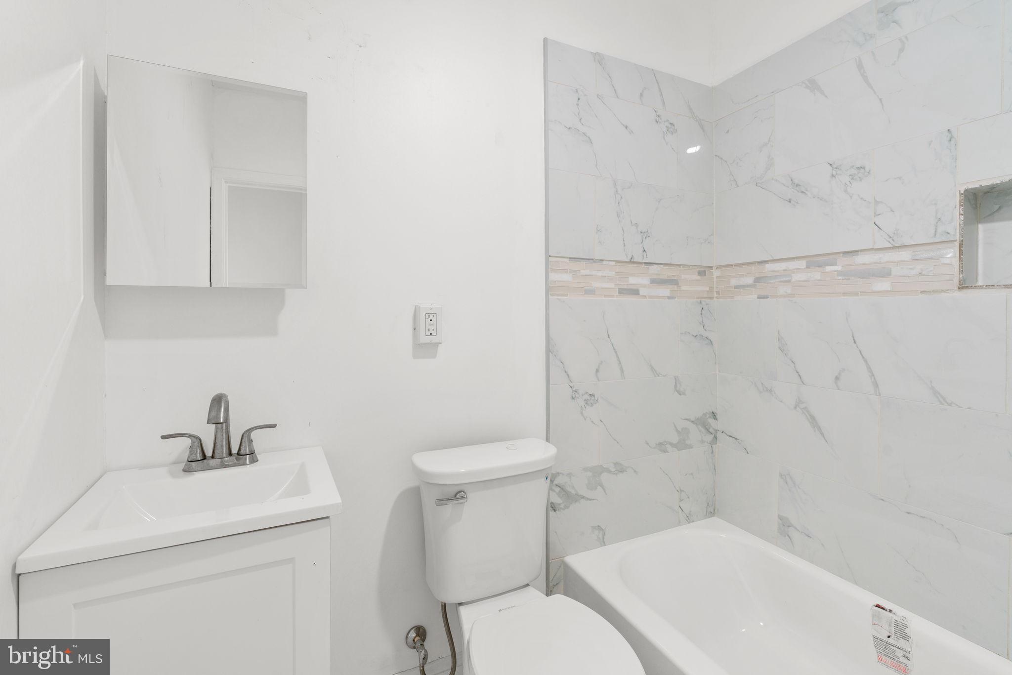 1731 Cliftview Avenue Baltimore, MD 21213 - Photo 16 of 33 a bathroom with a sink toilet and shower