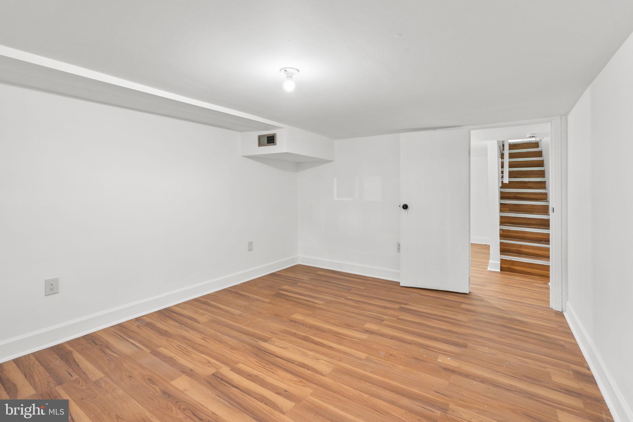 1731 Cliftview Avenue Baltimore, MD 21213 - Photo 24 of 33 a view of an empty room with wooden floor