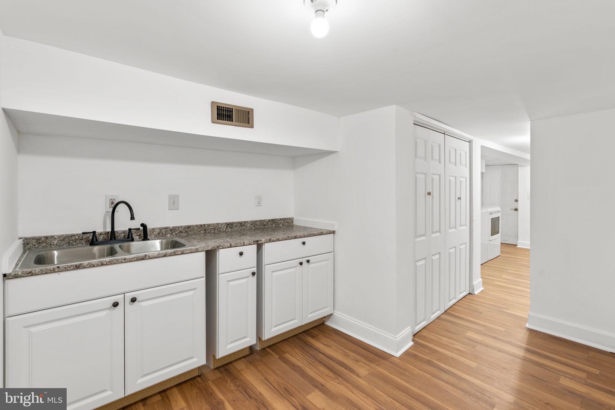 1731 Cliftview Avenue Baltimore, MD 21213 - Photo 25 of 33 a kitchen with a sink and cabinets