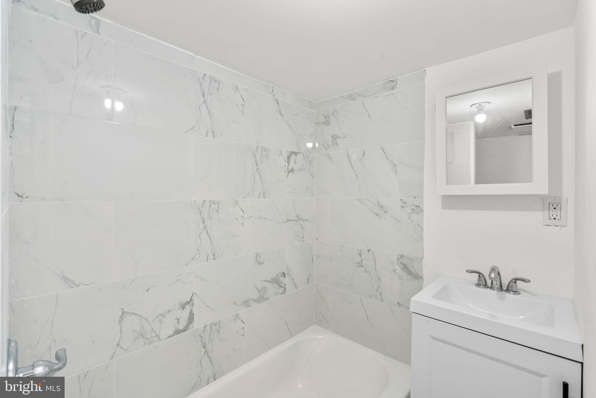 1731 Cliftview Avenue Baltimore, MD 21213 - Photo 27 of 33 a bathroom with a sink toilet and shower