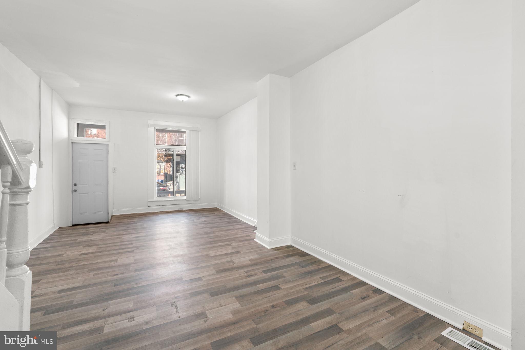 1731 Cliftview Avenue Baltimore, MD 21213 - Photo 8 of 33 an empty room with wooden floor and windows