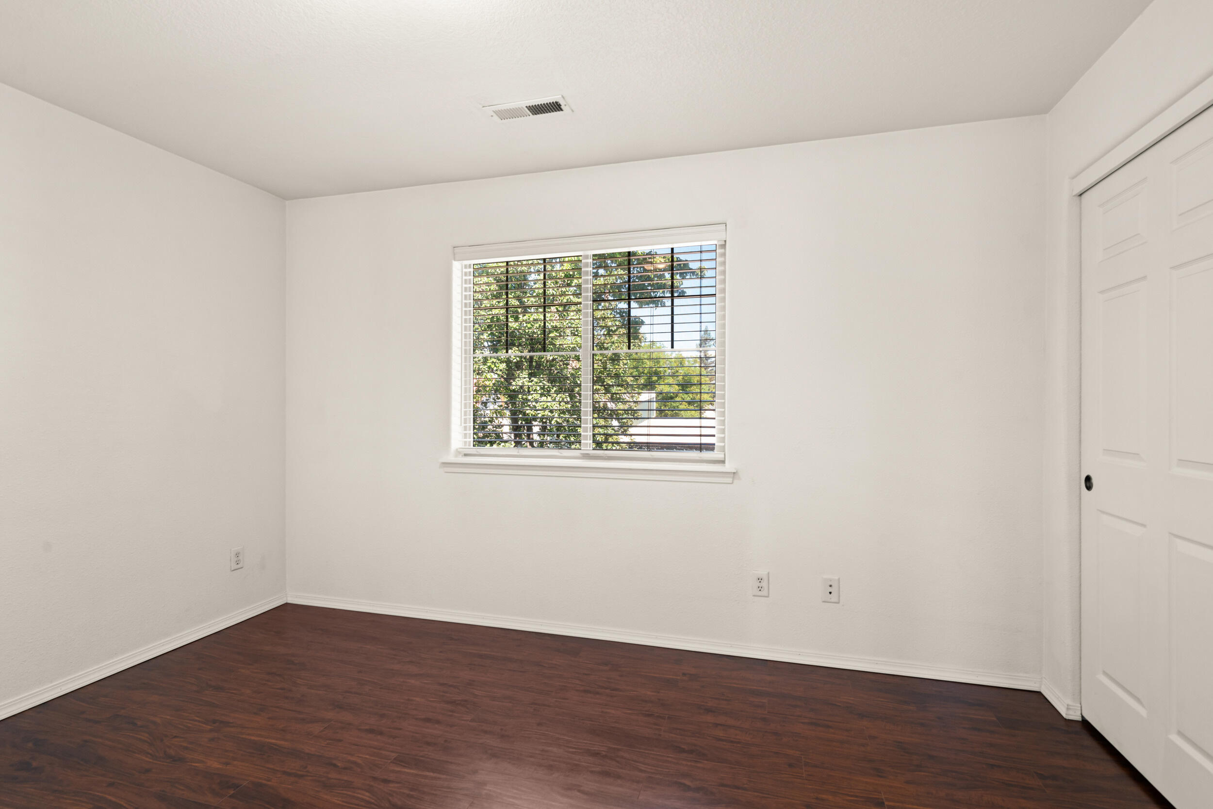 450 Midway Road, Unit 33 Medford, OR 97501 - Photo 12 of 21 an empty room with wooden floor and windows