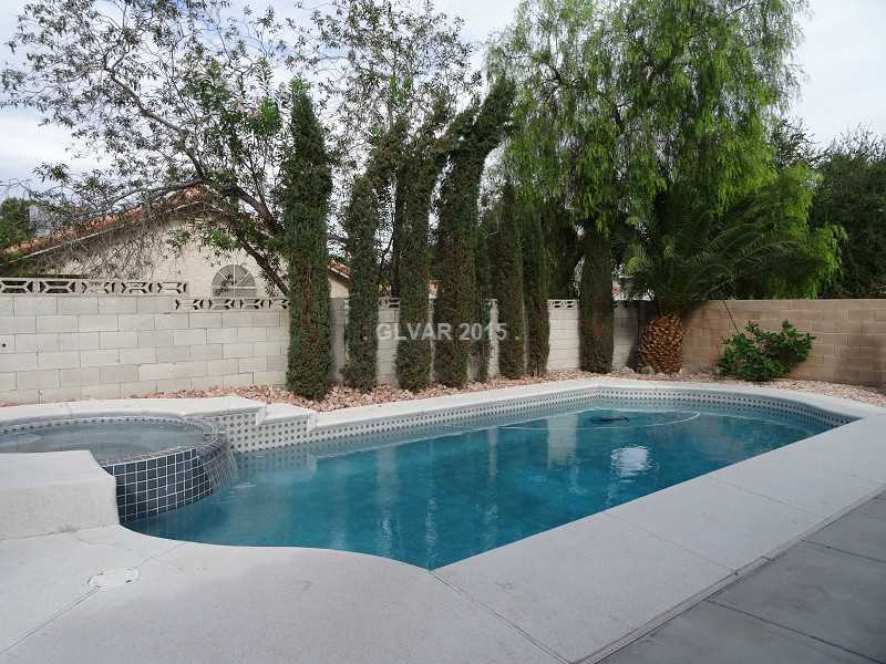 2800 Mirage Road Henderson, NV 89074 - Photo 29 of 35 Swimming Pool/Hot Tub/Sauna. Swimming Pool, Spa, Mature Landscaping. Water fall from spa into pool.