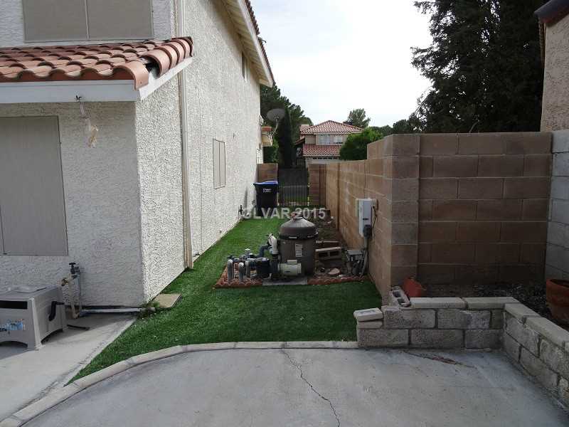 2800 Mirage Road Henderson, NV 89074 - Photo 33 of 35 Yard/Garden. Pool equipment on side of house. Artificial grass. Herb garden behind pool equipment.