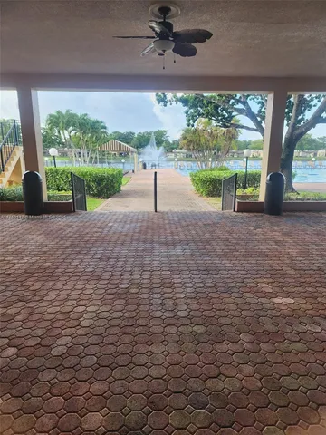 a view of swimming pool with outdoor seating and lake in the back