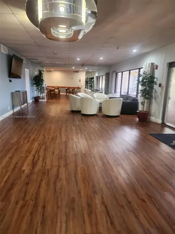 a room with lots of furniture and wooden floor