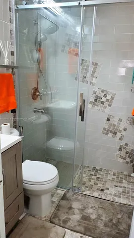a bathroom with a toilet and a shower