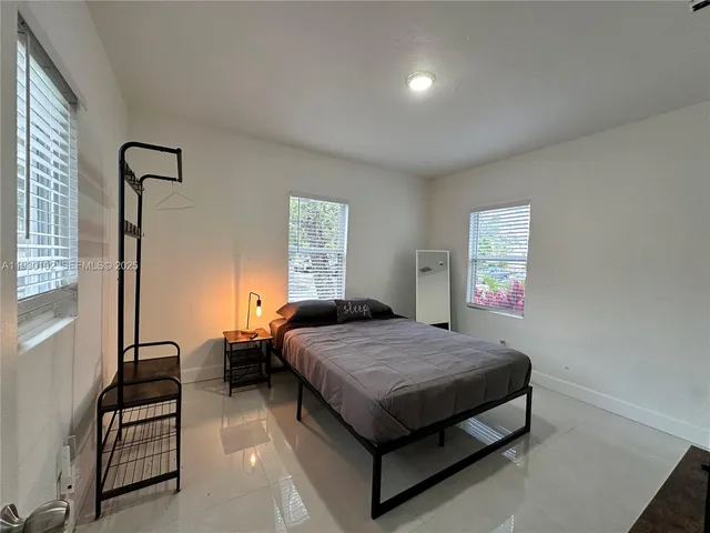 a bedroom with a bed and window