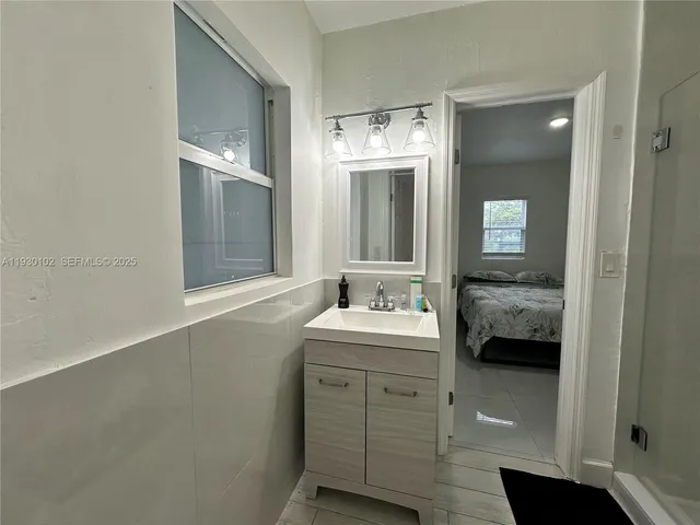 a en suite bathroom with a toilet sink and mirror