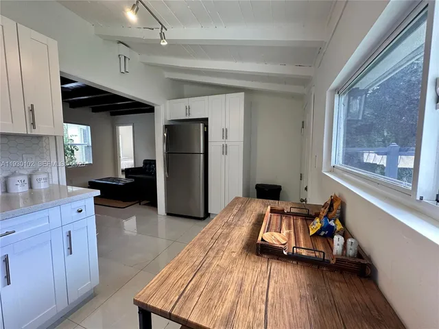 a kitchen with a refrigerator and a sink
