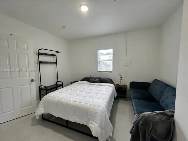 a bedroom with a bed and window