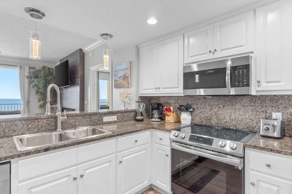 a kitchen with a sink stainless steel appliances and cabinets