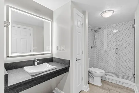 a bedroom with a bed and a ceiling fan