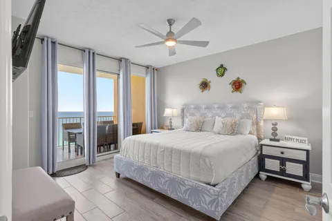 a bedroom with a bed window and a flat screen tv