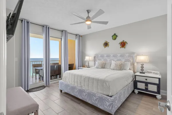 a bedroom with a bed window and a flat screen tv