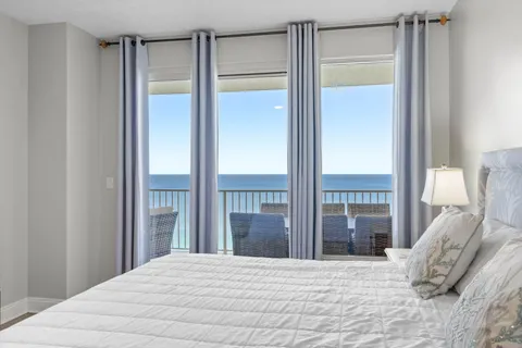 a bedroom with a large bed and a chandelier