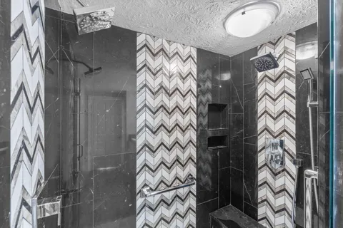 a bathroom with a bathtub sink and mirror