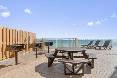 a roof deck with table and chairs