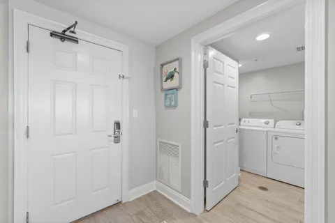 a view of a hallway with wooden floor