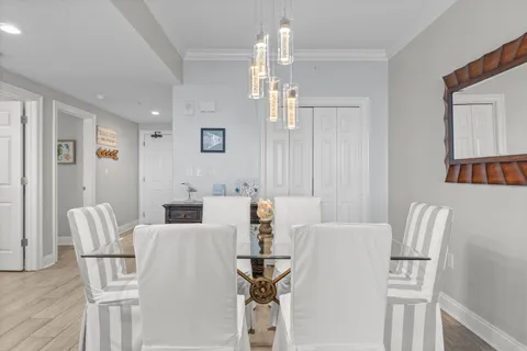a large white kitchen with wooden floor and a sink