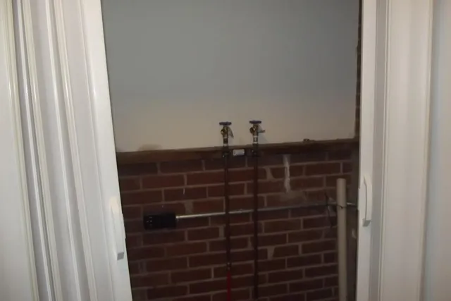 a bathroom with a shower and a sink