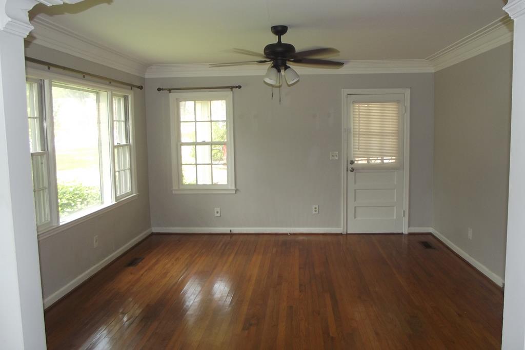 1702 42nd Street Columbus, GA 31904 - Photo 2 of 13 a view of an empty room with wooden floor and a window