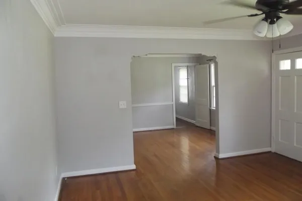 a view of a room with wooden floor and a window