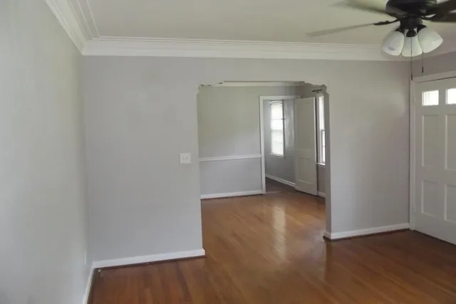 a view of a room with wooden floor and a window