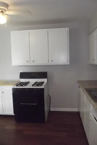 a stove top oven sitting inside of a kitchen