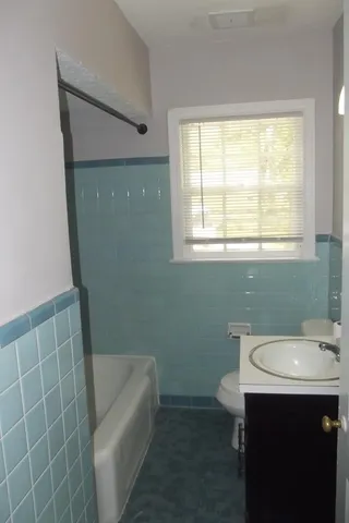 a bathroom with a sink a toilet and bathtub