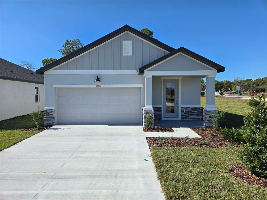 3808 Daybreak Run Loop Spring Hill, FL 34609 - Photo 1 of 14 a front view of a house with garden