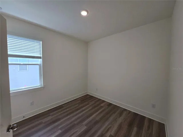 a view of an empty room and wooden floor