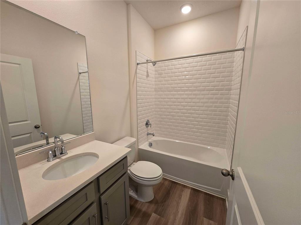 3808 Daybreak Run Loop Spring Hill, FL 34609 - Photo 6 of 14 a bathroom with a toilet a sink and a bathtub