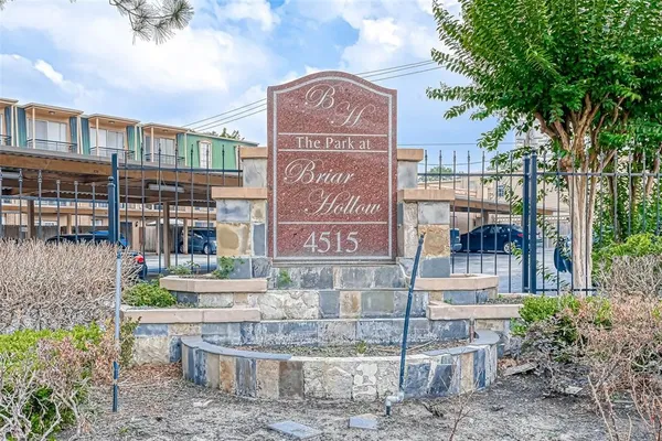 a view of a brick building with a tree in front