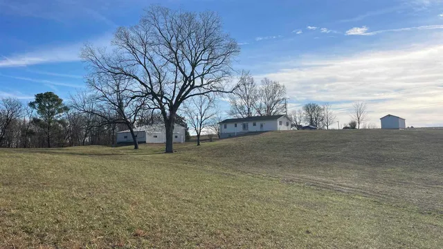a view of a house with a yard and sitting area