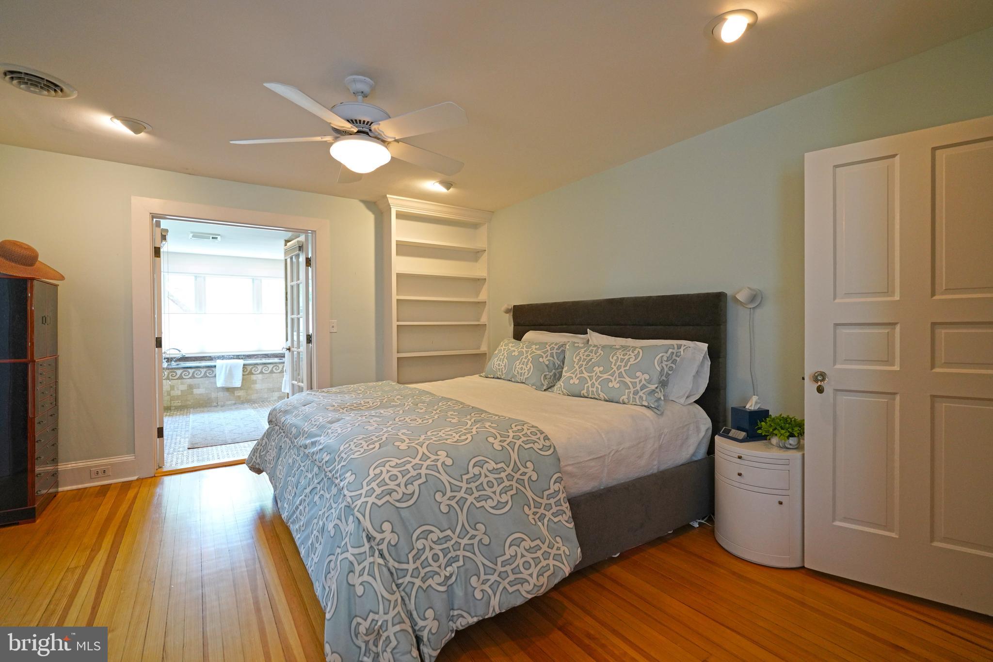 240 2nd Street Lewes, DE 19958 - Photo 46 of 90 a spacious bedroom with a bed and wooden floor