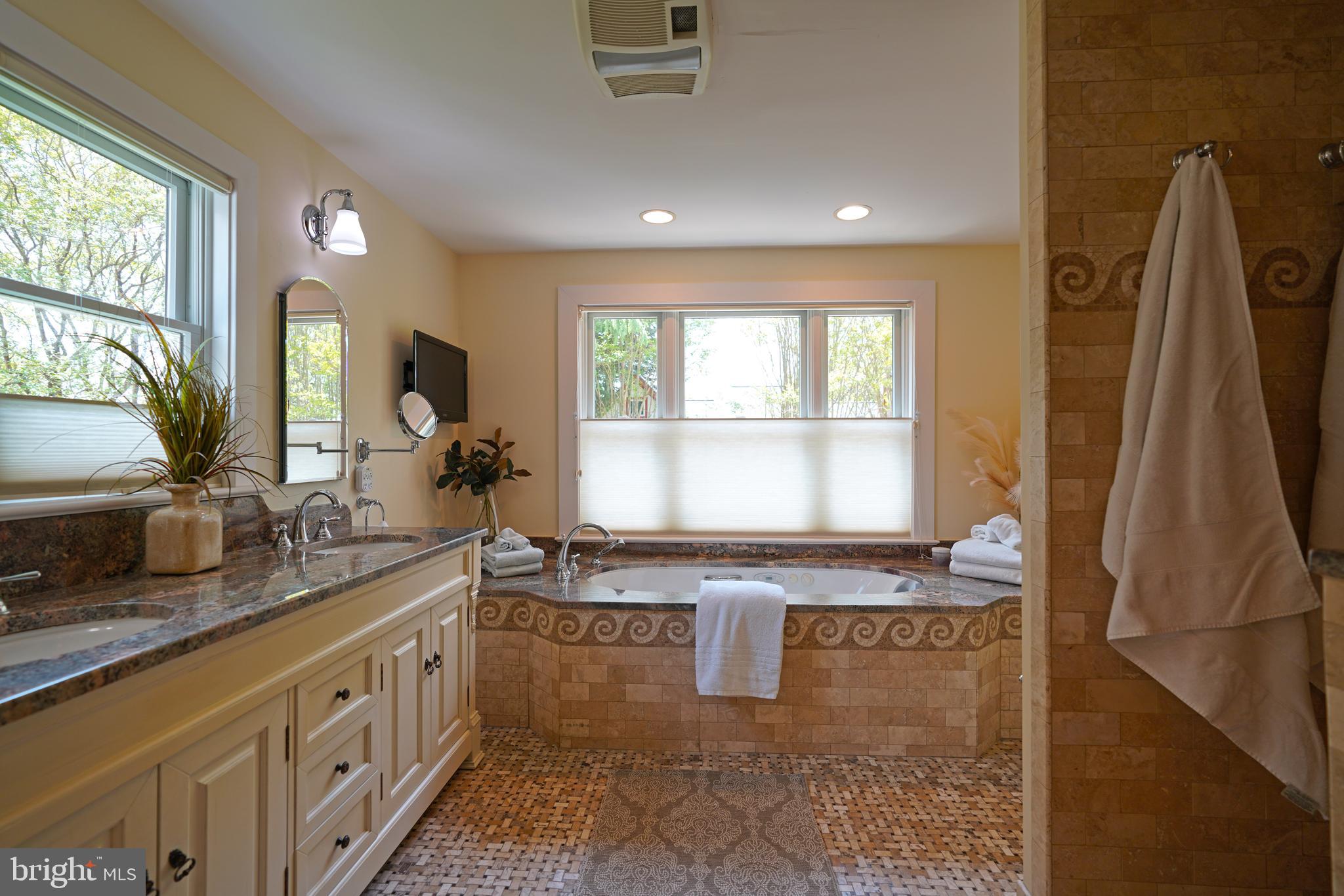 240 2nd Street Lewes, DE 19958 - Photo 49 of 90 a bathroom with a granite countertop sink a mirror and a bathtub