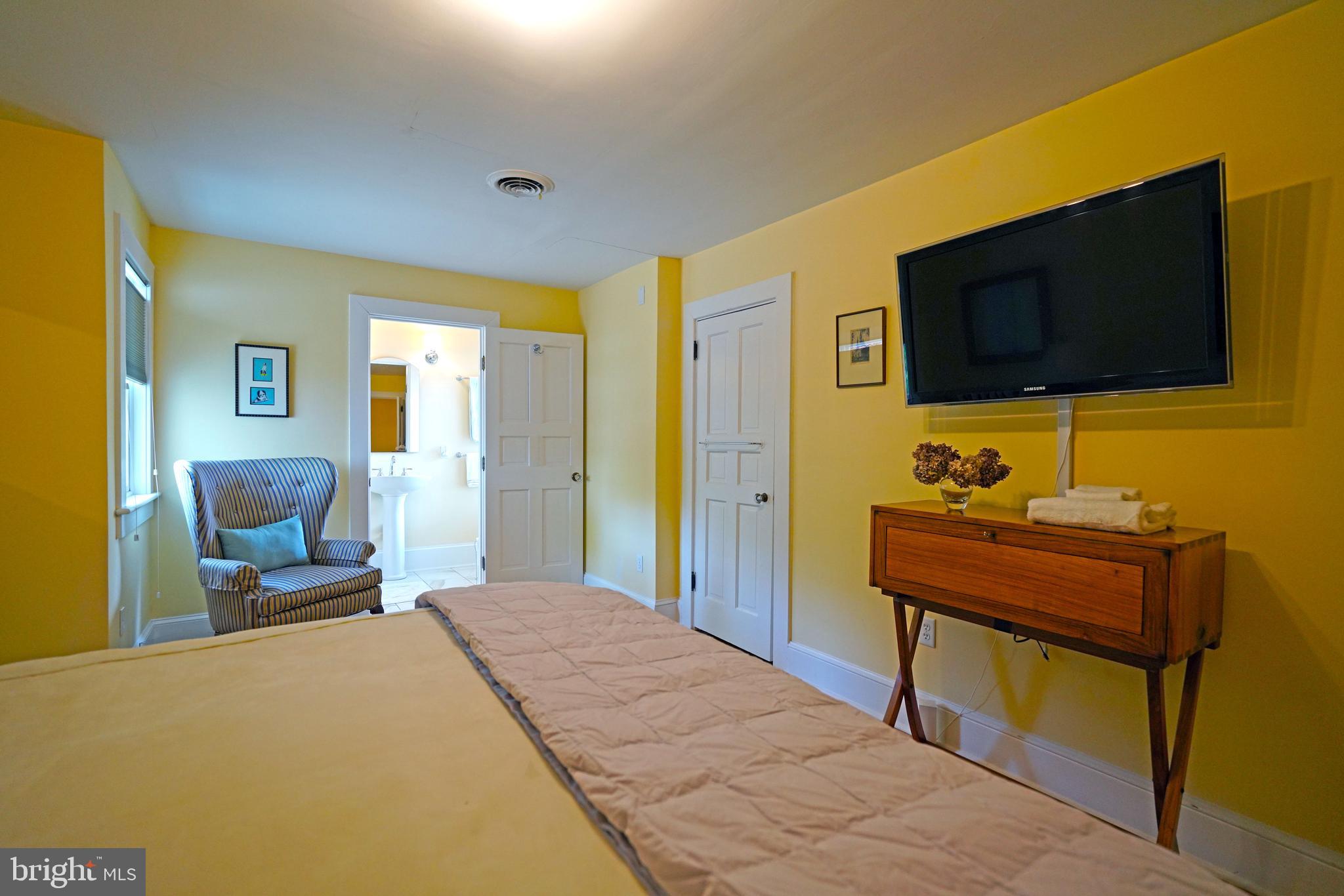 240 2nd Street Lewes, DE 19958 - Photo 57 of 90 a bedroom with a bed and a flat screen tv