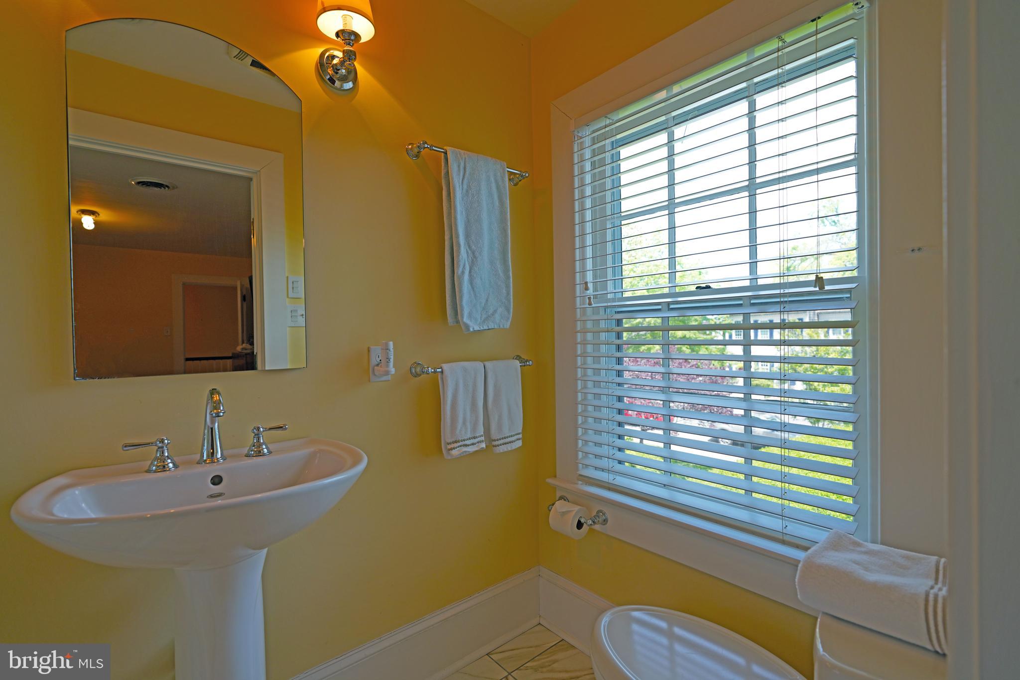 240 2nd Street Lewes, DE 19958 - Photo 59 of 90 a bathroom with a sink and a mirror
