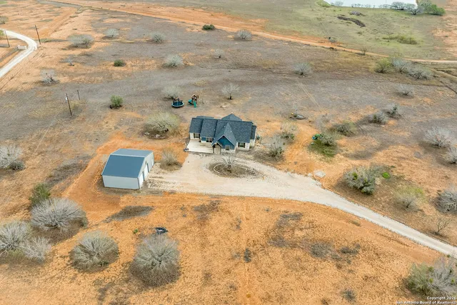 a view of beach and small yard