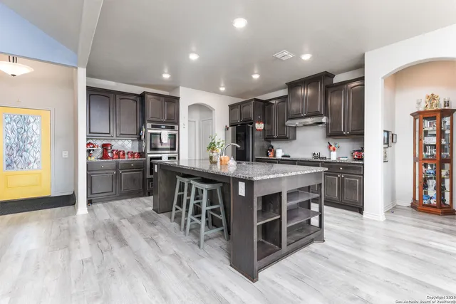 a dining room with furniture a floor to ceiling window and a chandelier