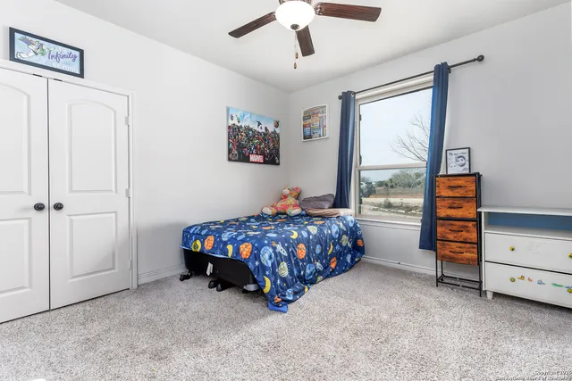 a bed sitting in a bedroom next to a window